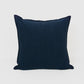 a dark blue pillow on a white background