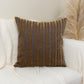 a white couch with a striped pillow on it