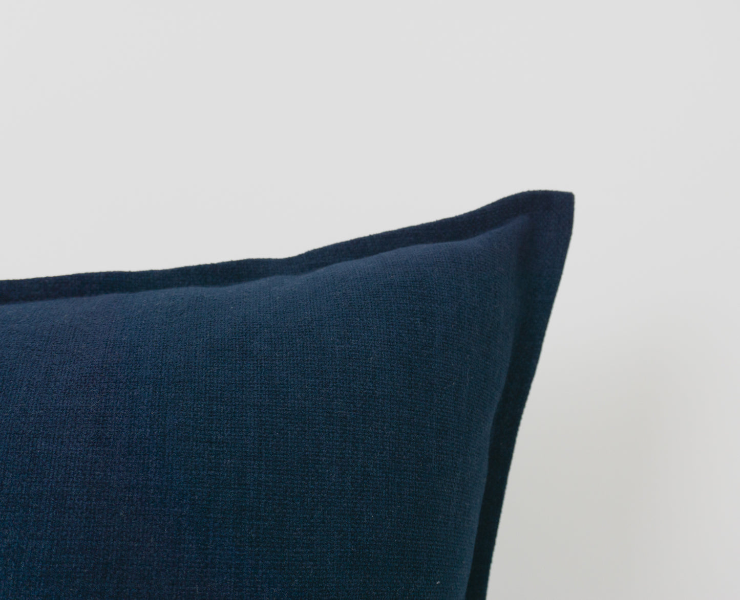 a blue pillow sitting on top of a white table